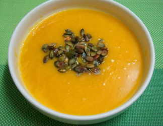 cream of pumpkin soup with pumpkin seeds.