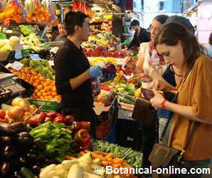 mujer comprando fruta en un mercado